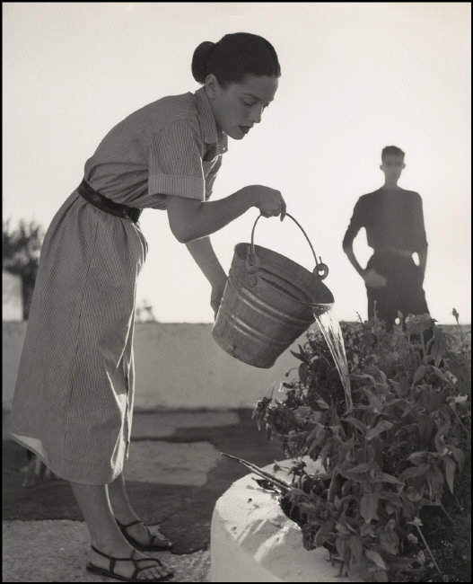 1953-Herbert-List-Forio-On-the-terrace-of-the-Villa-Punta-Caruso.-The-wife-of-the-American-painter-Carlyle-Brown-Margery-Brown-waters-the-plants-as-he-looks